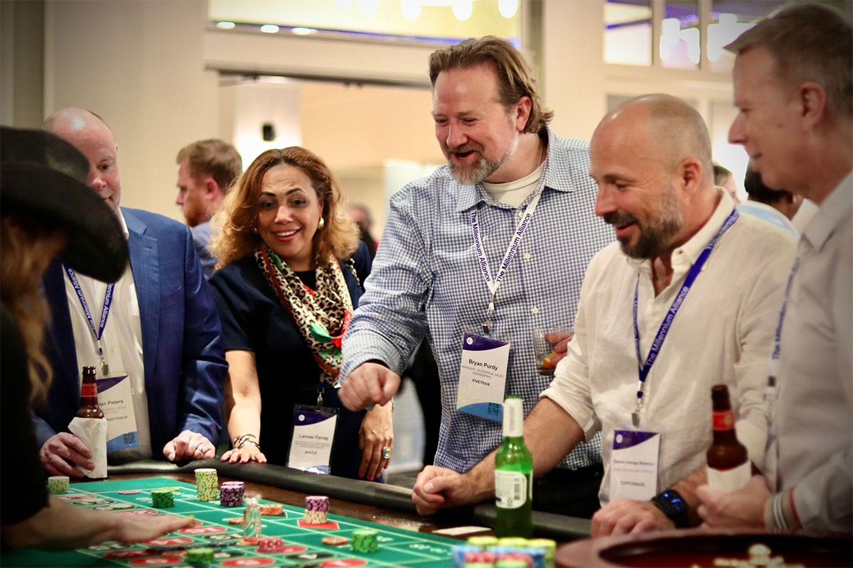 Corporate guests laughing at a roulette table at an Austin Casino Party USA event
