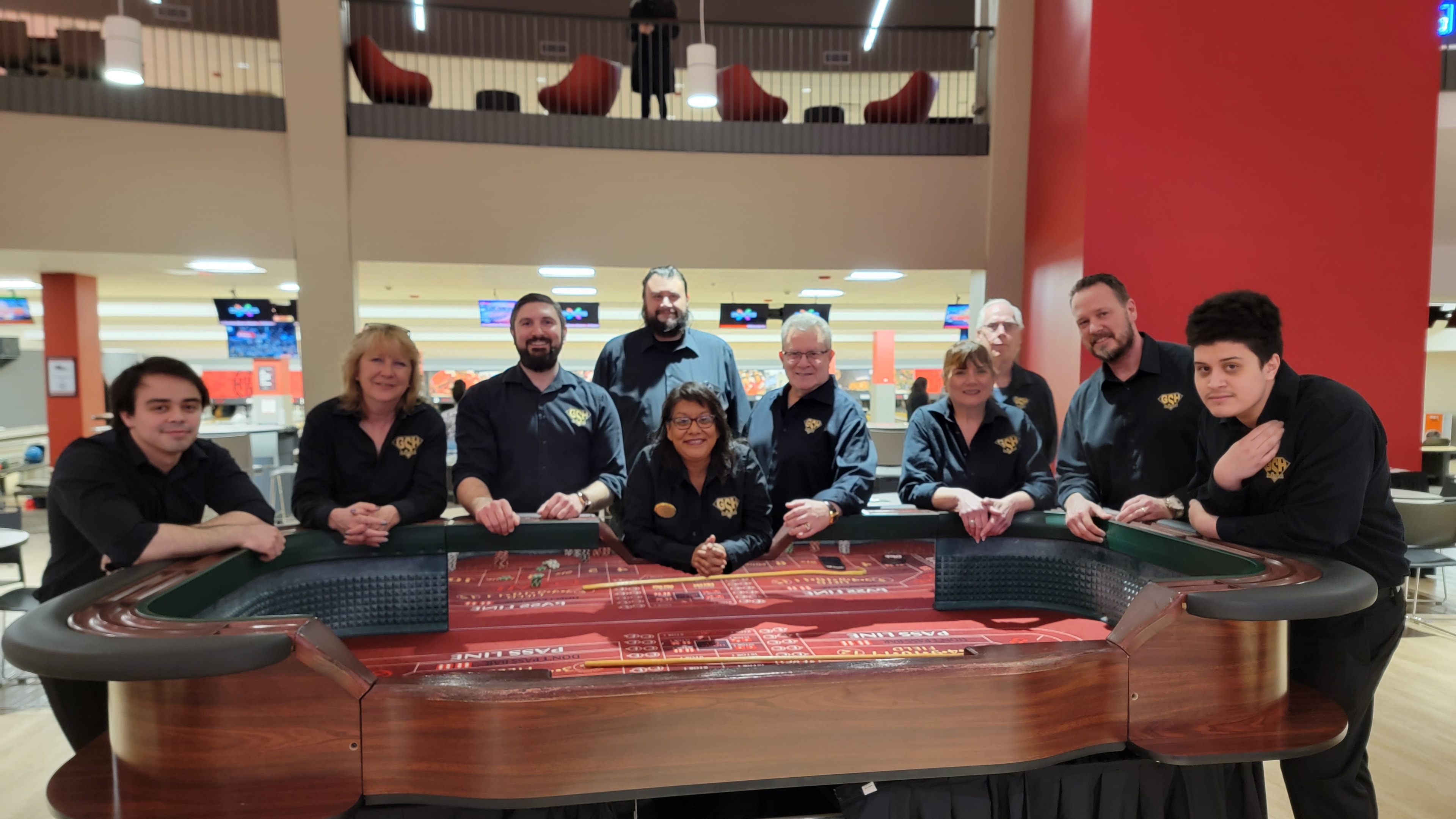 Group of guests smiling around a roulette table at a Casino Party USA event