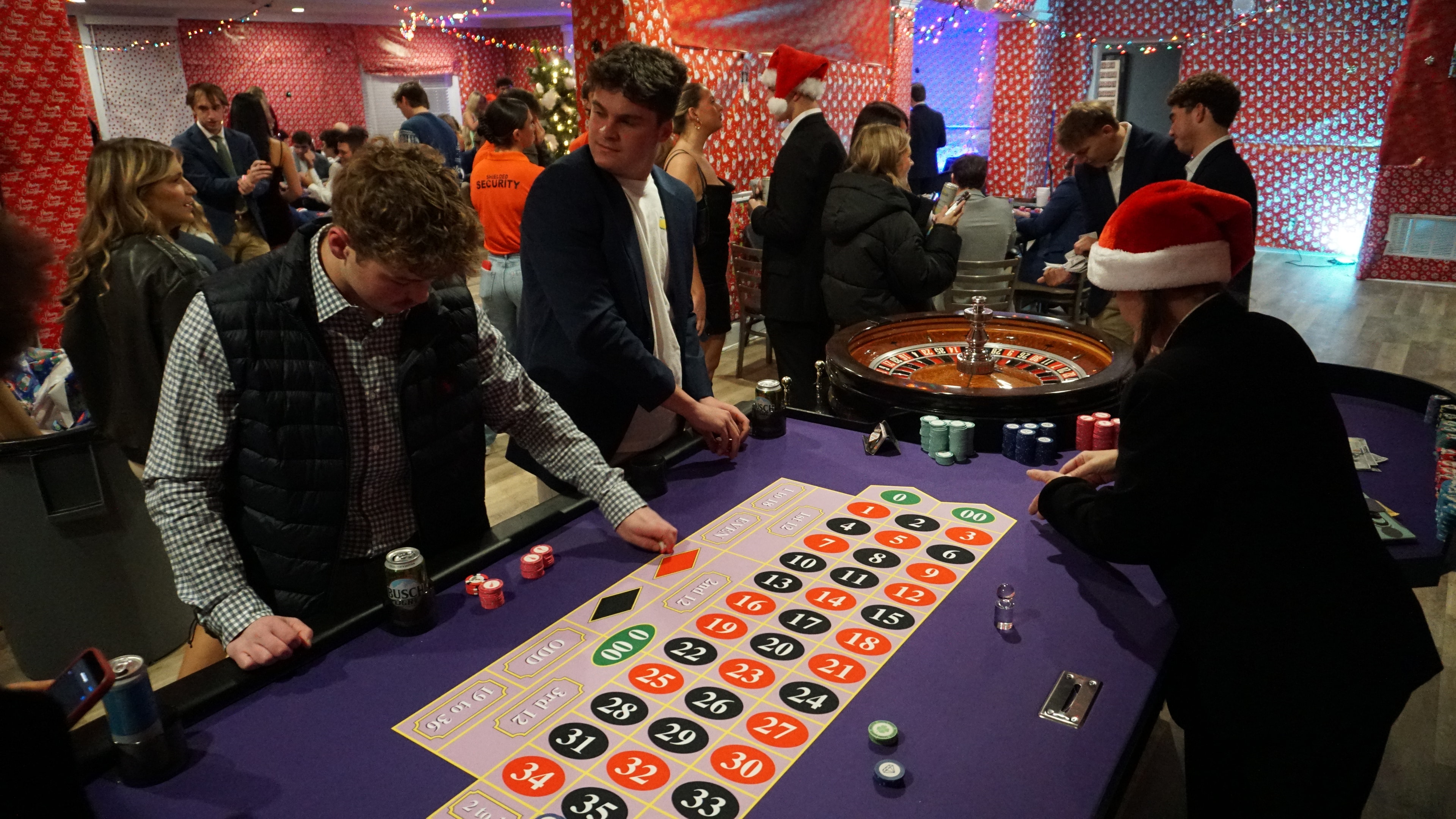 Guests and dealers smiling around a Casino Party USA blackjack table in an elegant ballroom