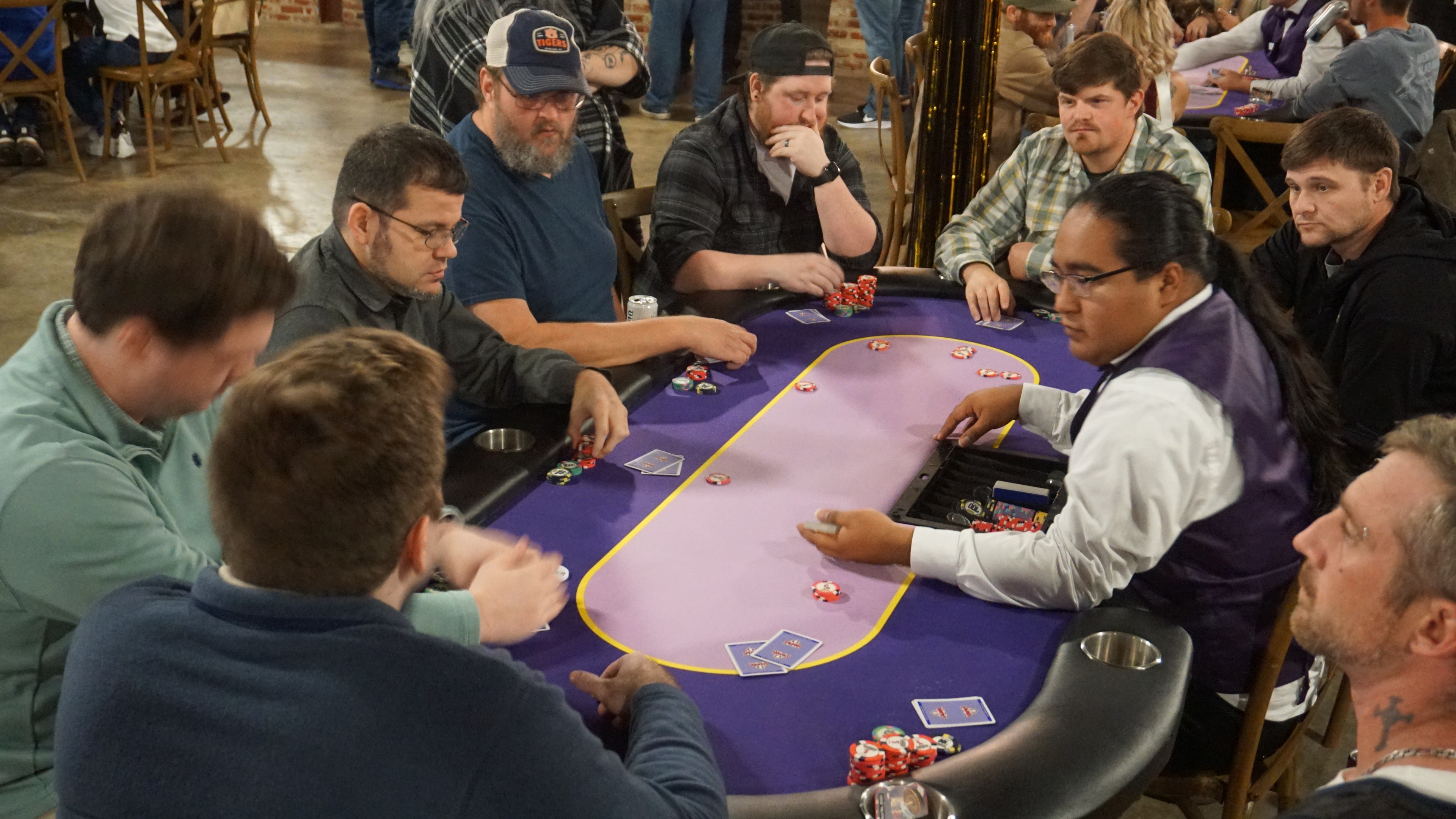 Guests playing blackjack at a Casino Party USA outdoor evening event with professional dealer