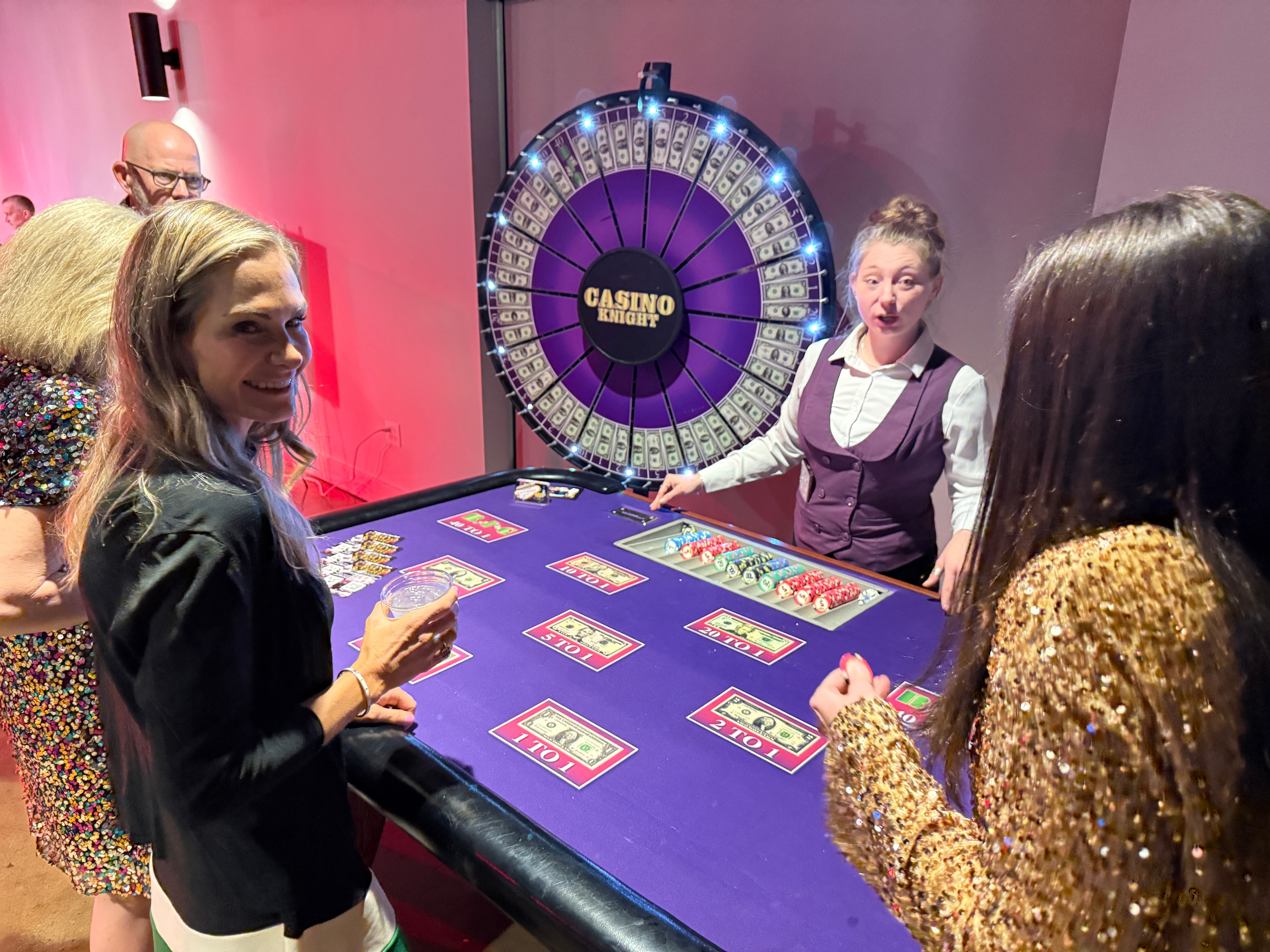 Guests seated at a Casino Party USA branded blackjack table in an elegant ballroom