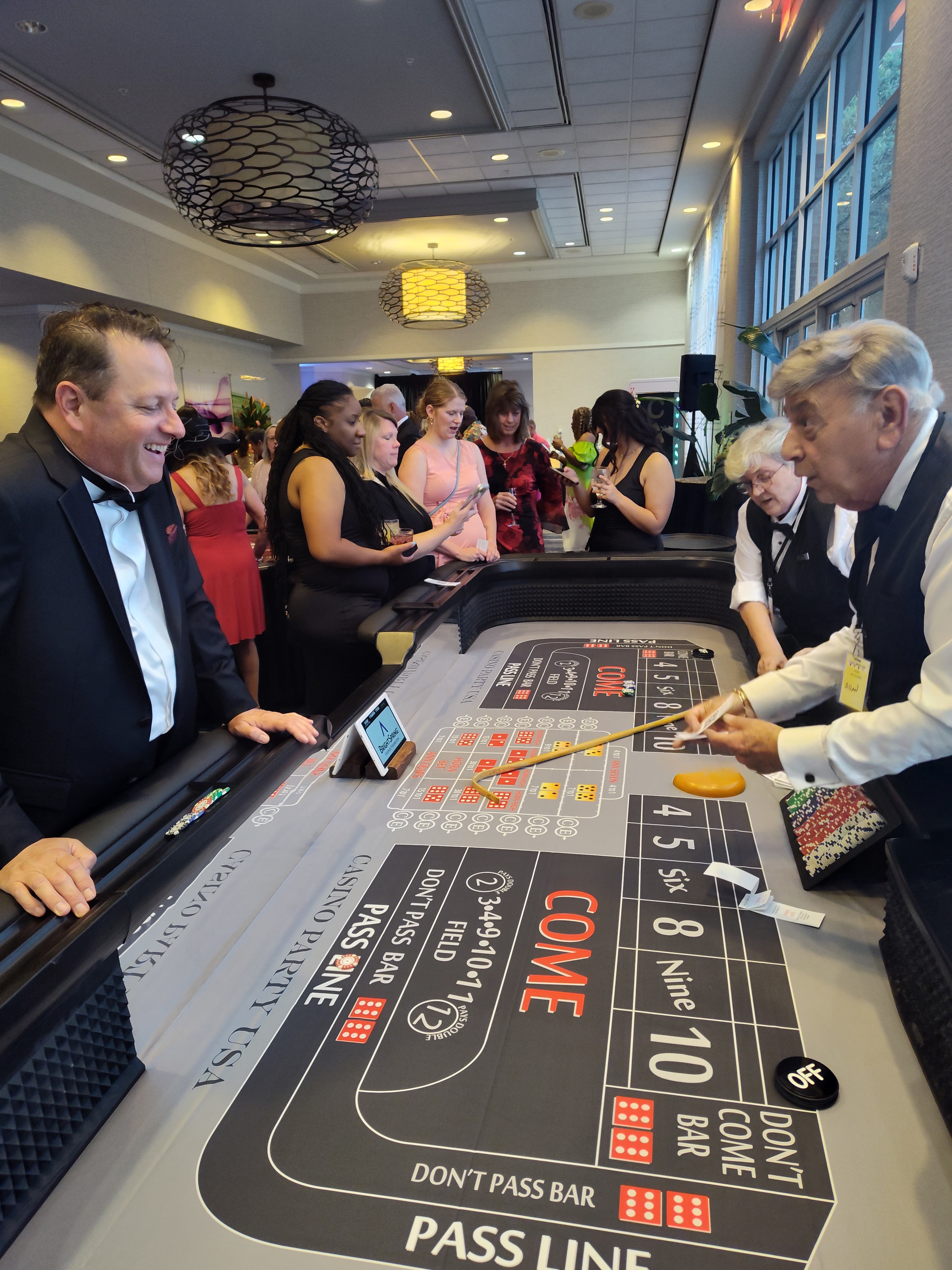 Guests and dealer at a Casino Party USA craps table at a Cheyenne event