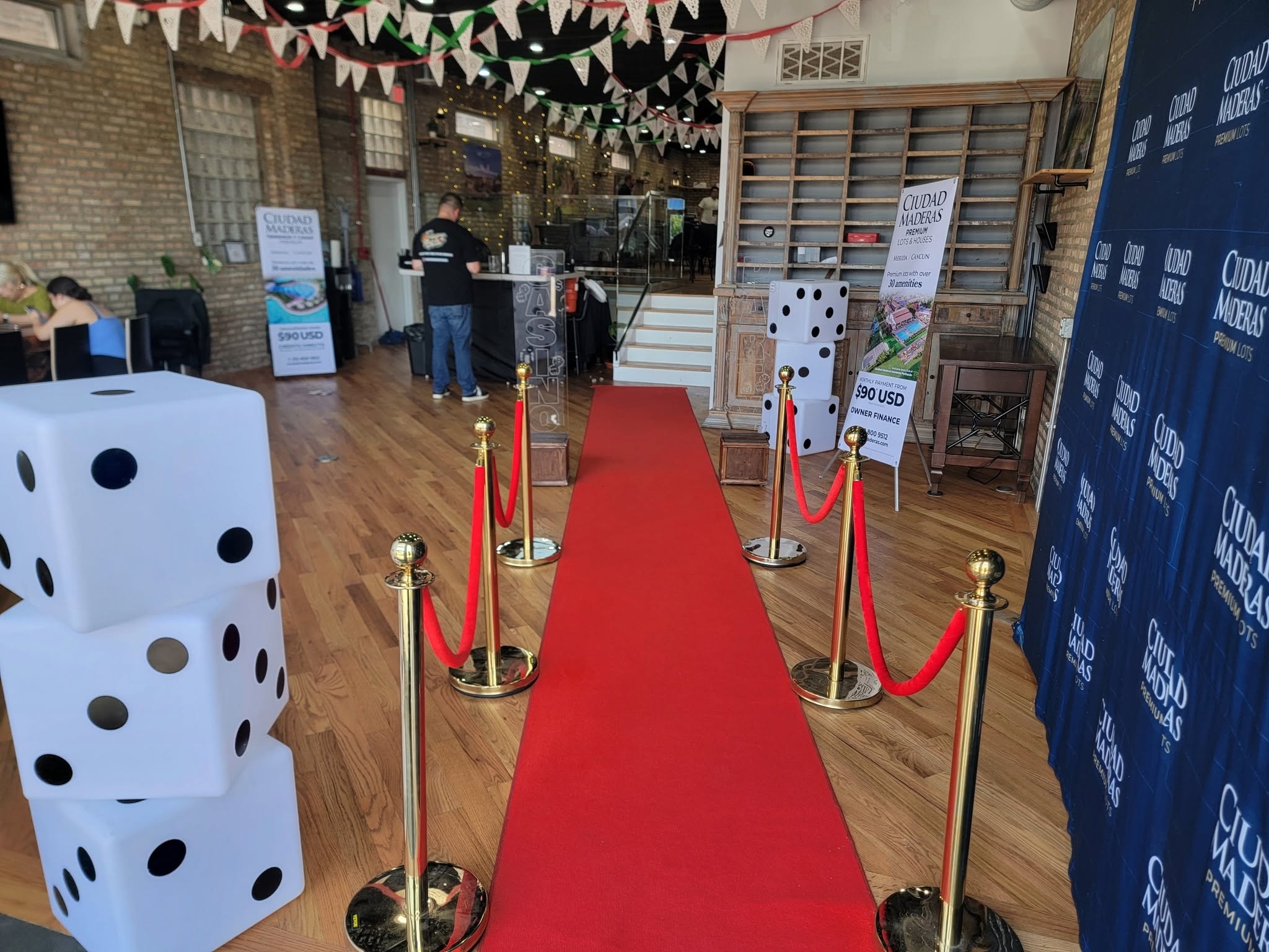 Red carpet casino entrance with oversized dice props and branded signage at a Chicago Casino Party USA event