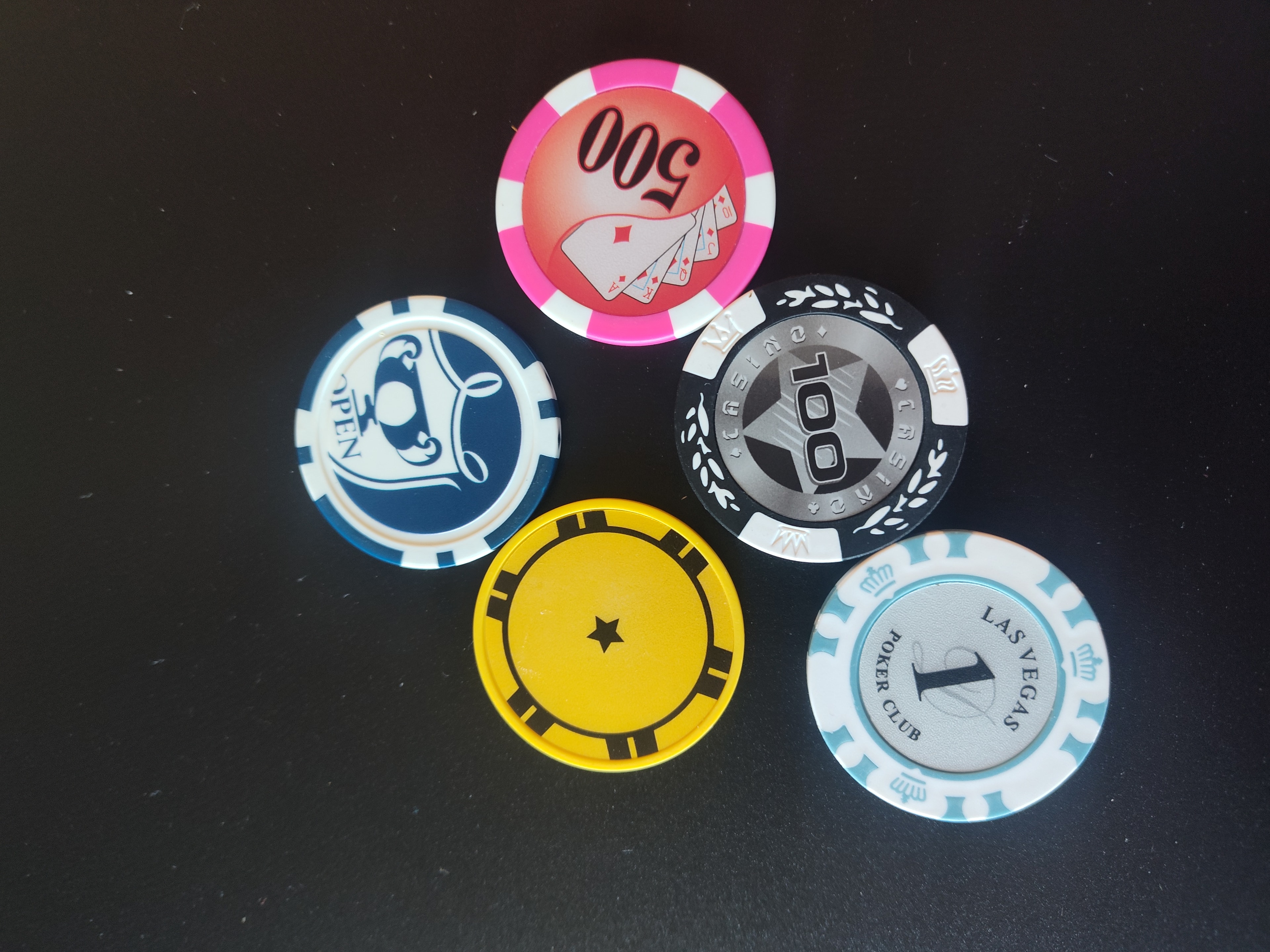 Stacks of custom casino poker chips in multiple colors — branded casino chips for corporate events and parties