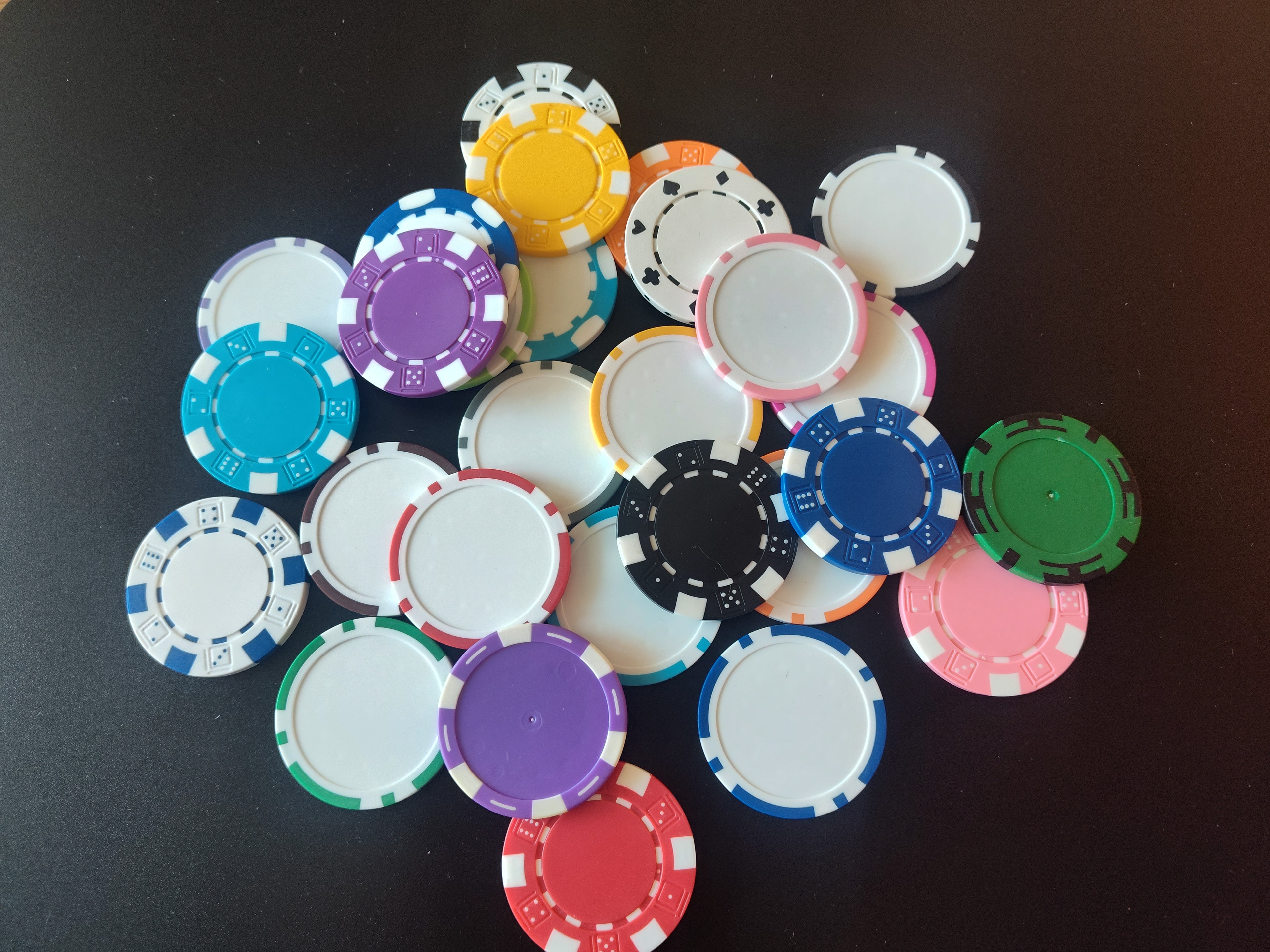 Custom casino chips arranged on blackjack table — logo casino chips for corporate events and fundraisers