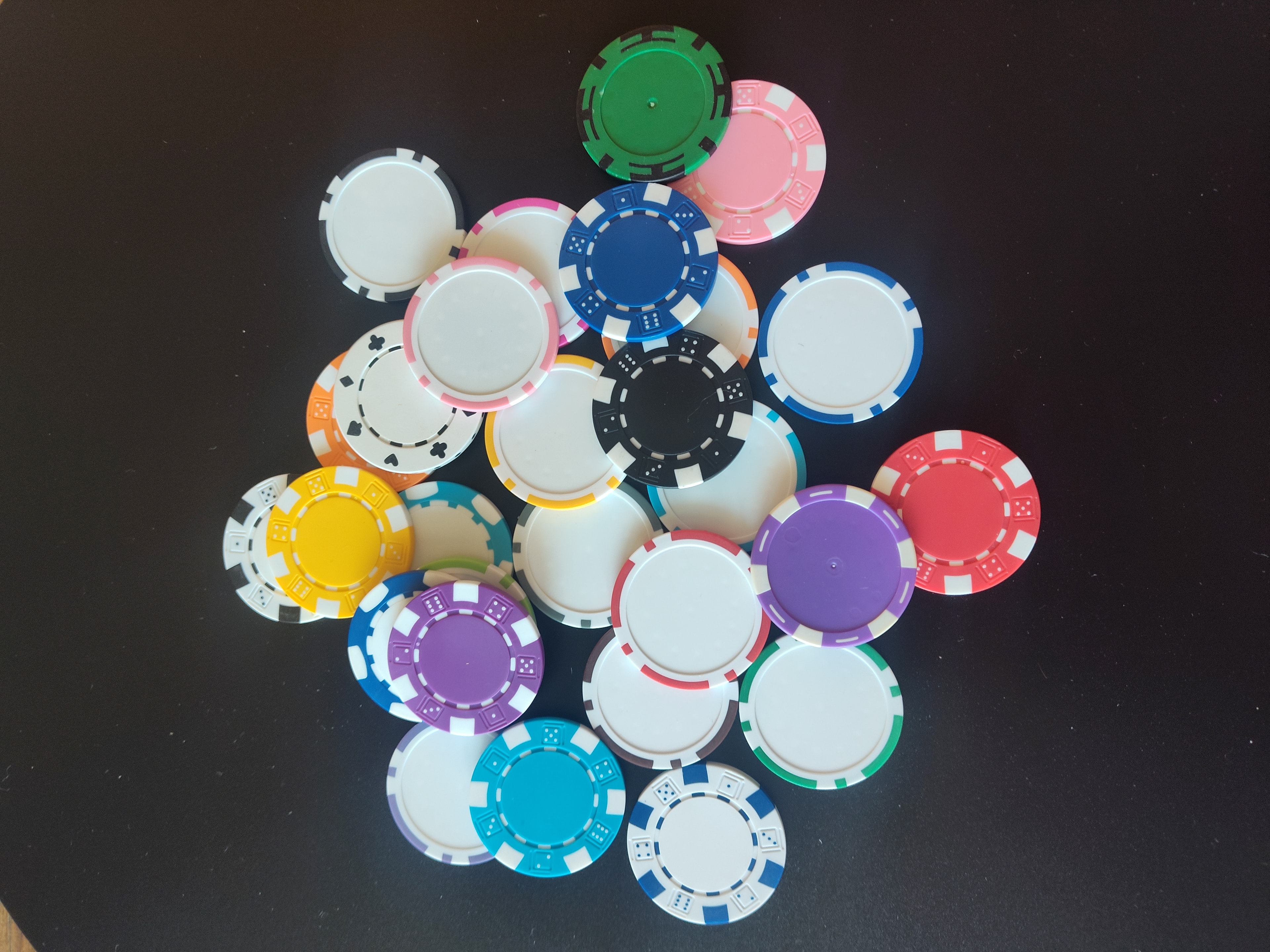 Colorful custom casino chips in red, blue, green and black — personalized casino chips as party favors and event keepsakes