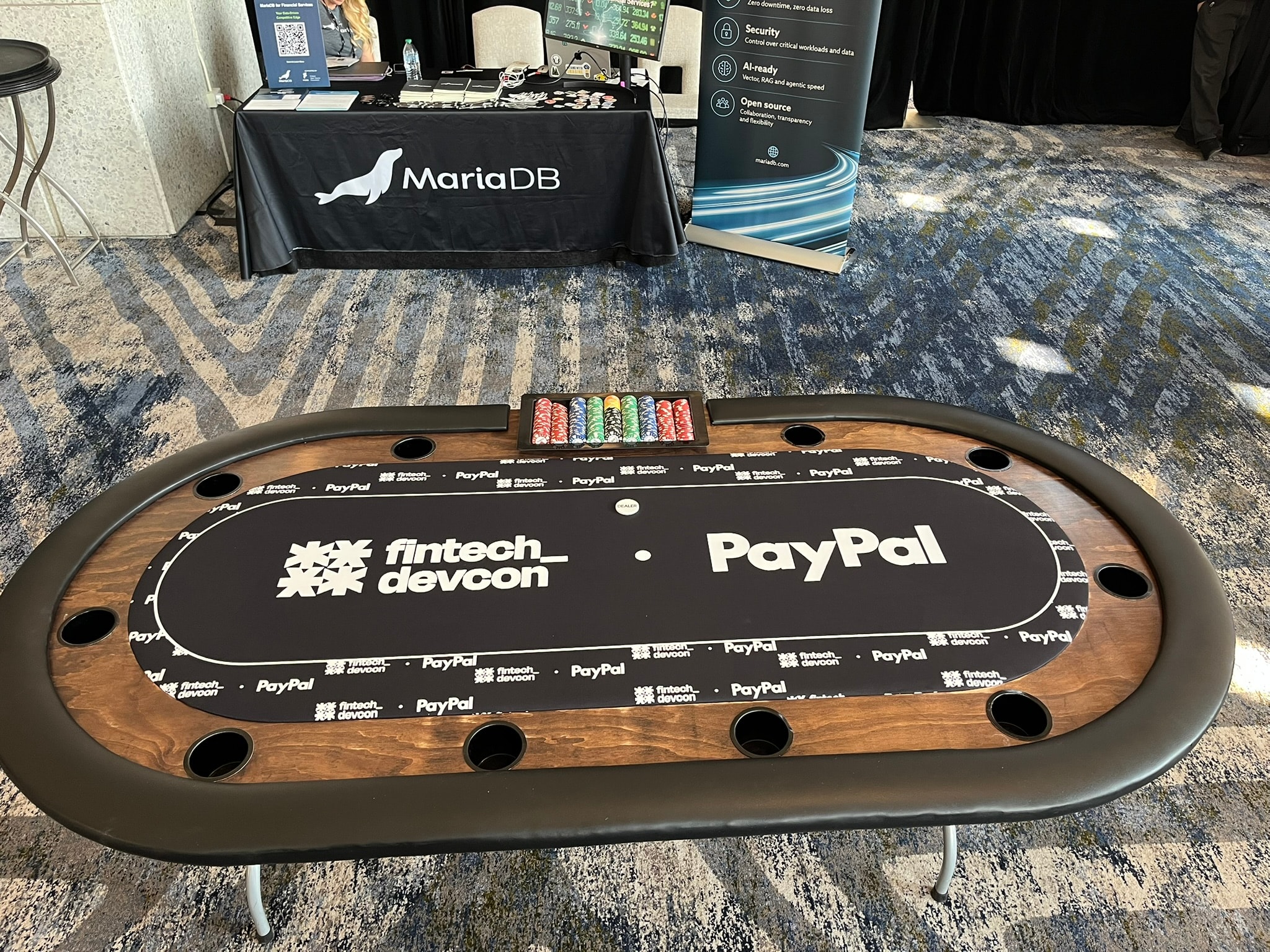 Custom branded poker table felt with PayPal and fintech devcon logos at corporate conference casino event