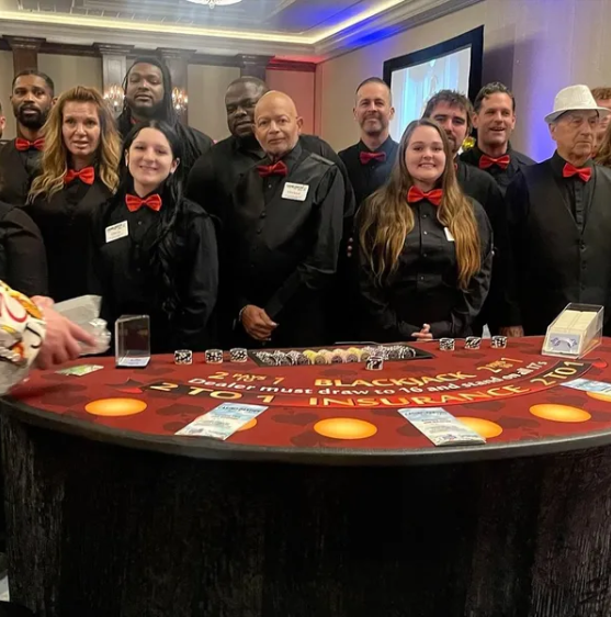 Casino Party USA dealer team posing at a blackjack table at a Dallas event
