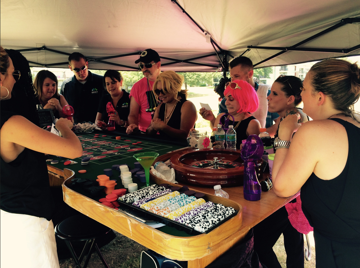 Guests playing roulette under an outdoor tent at a Dallas Casino Party USA event
