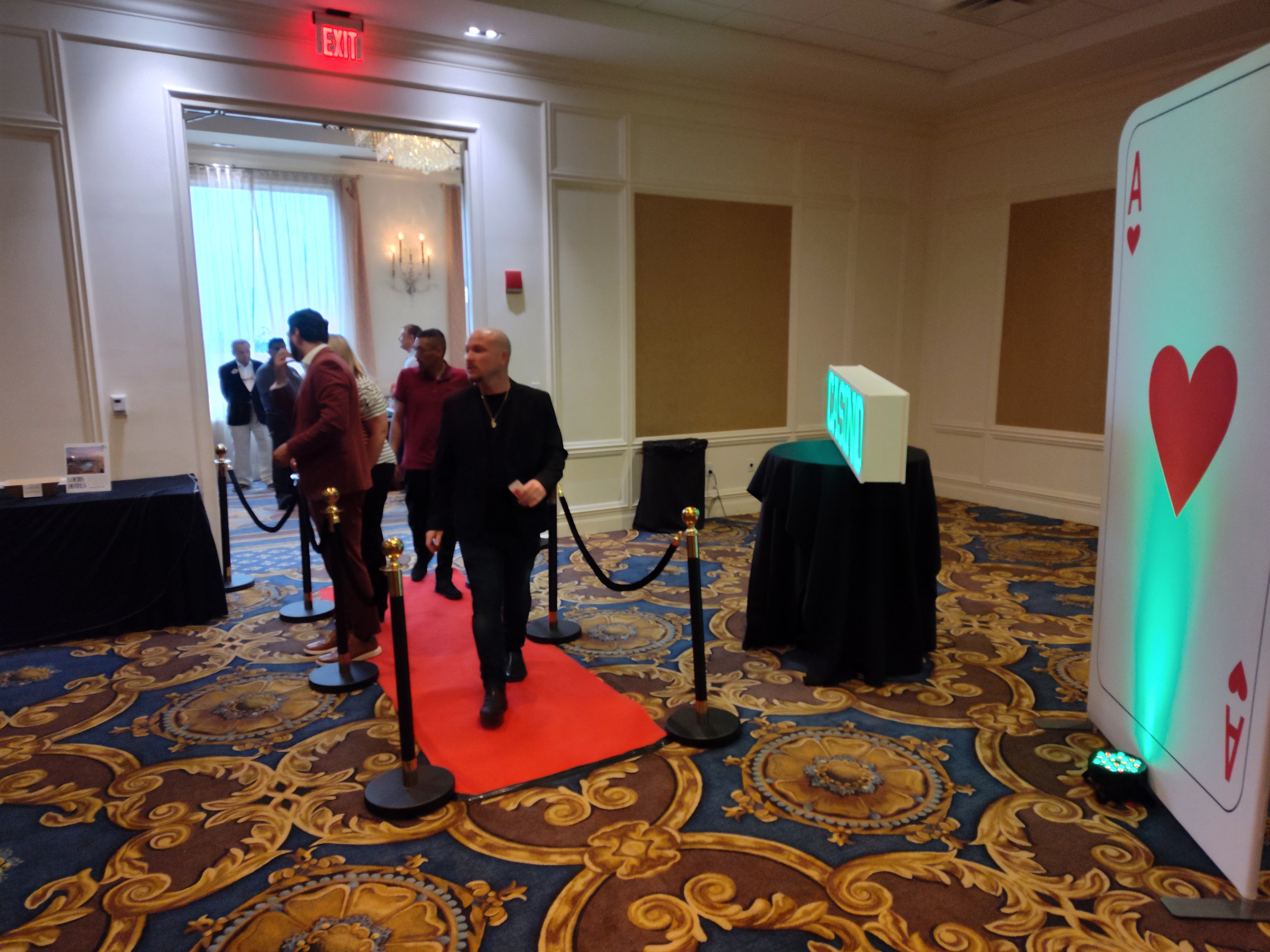 Casino party decorations — ballroom entrance with Ace of Hearts card prop