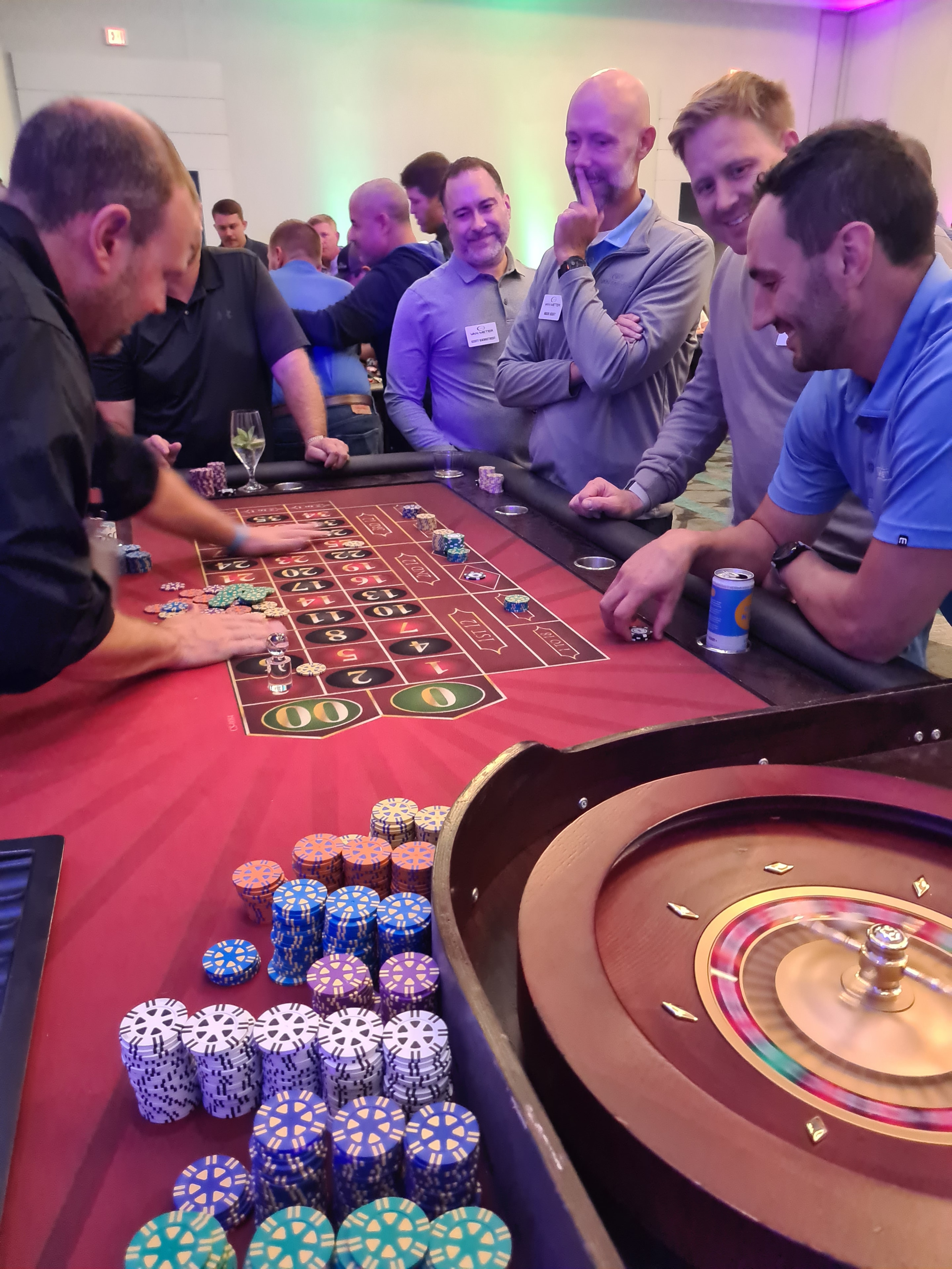 Guests crowded around a roulette table at a Des Moines casino event