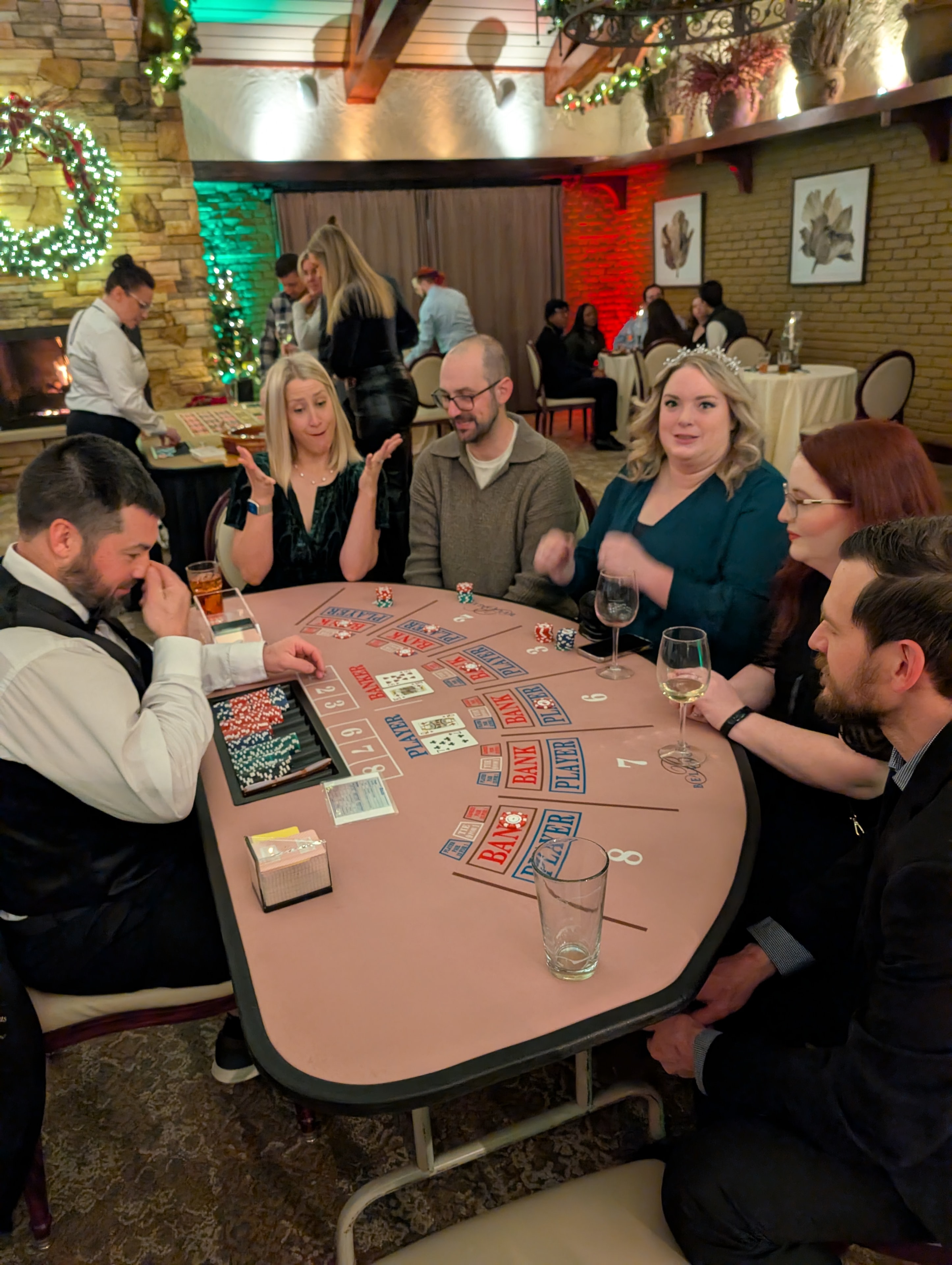 Guests playing baccarat at a Casino Party USA table at a Detroit holiday casino event