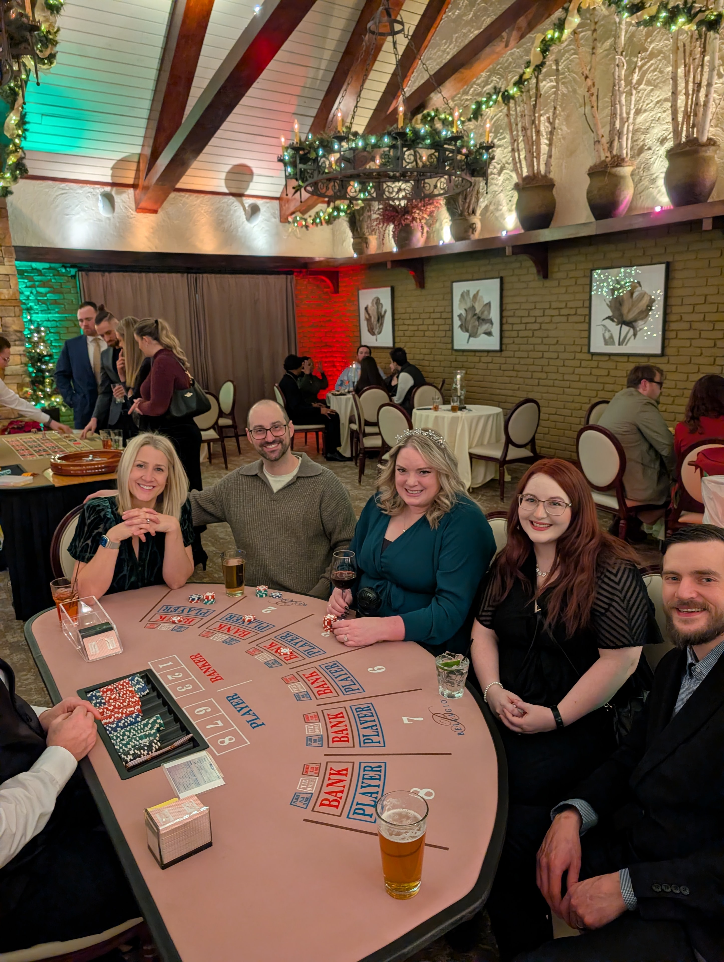 Guests smiling at a Casino Party USA blackjack table at a Detroit holiday event