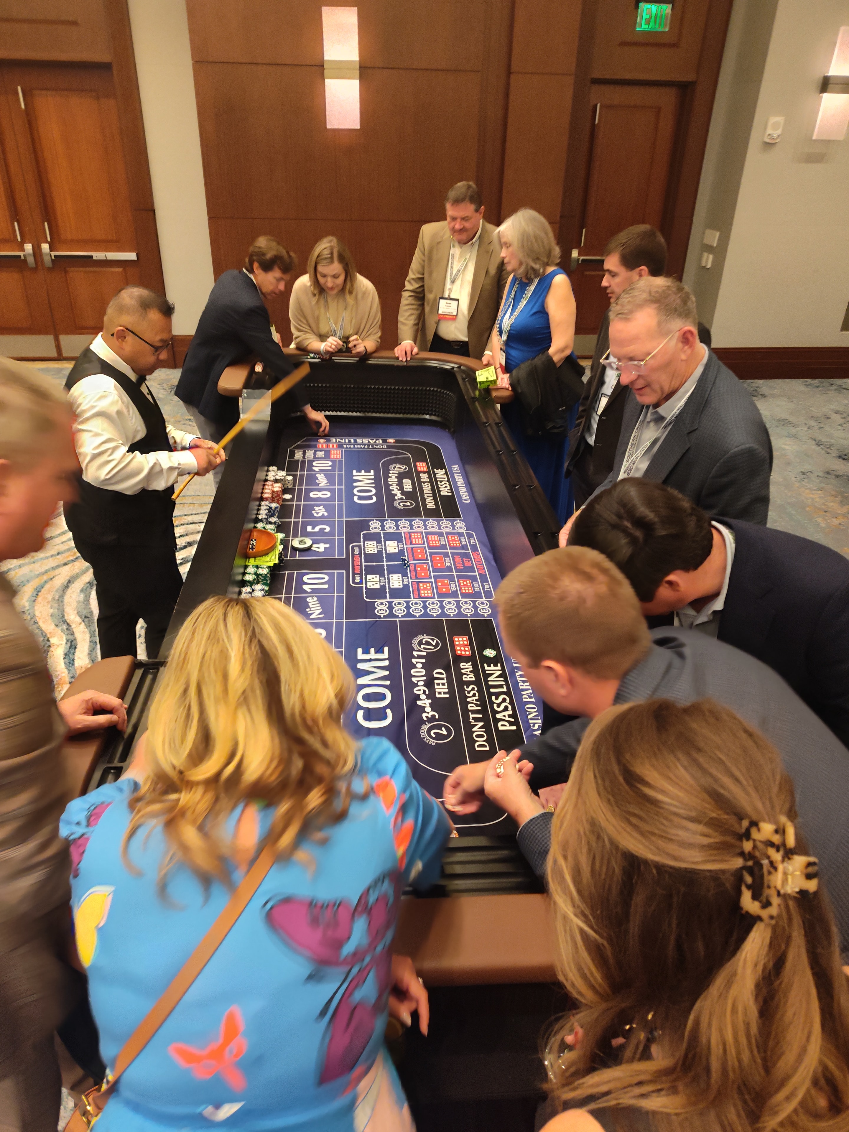 Overhead view of a packed Casino Party USA craps table at a Jacksonville corporate event