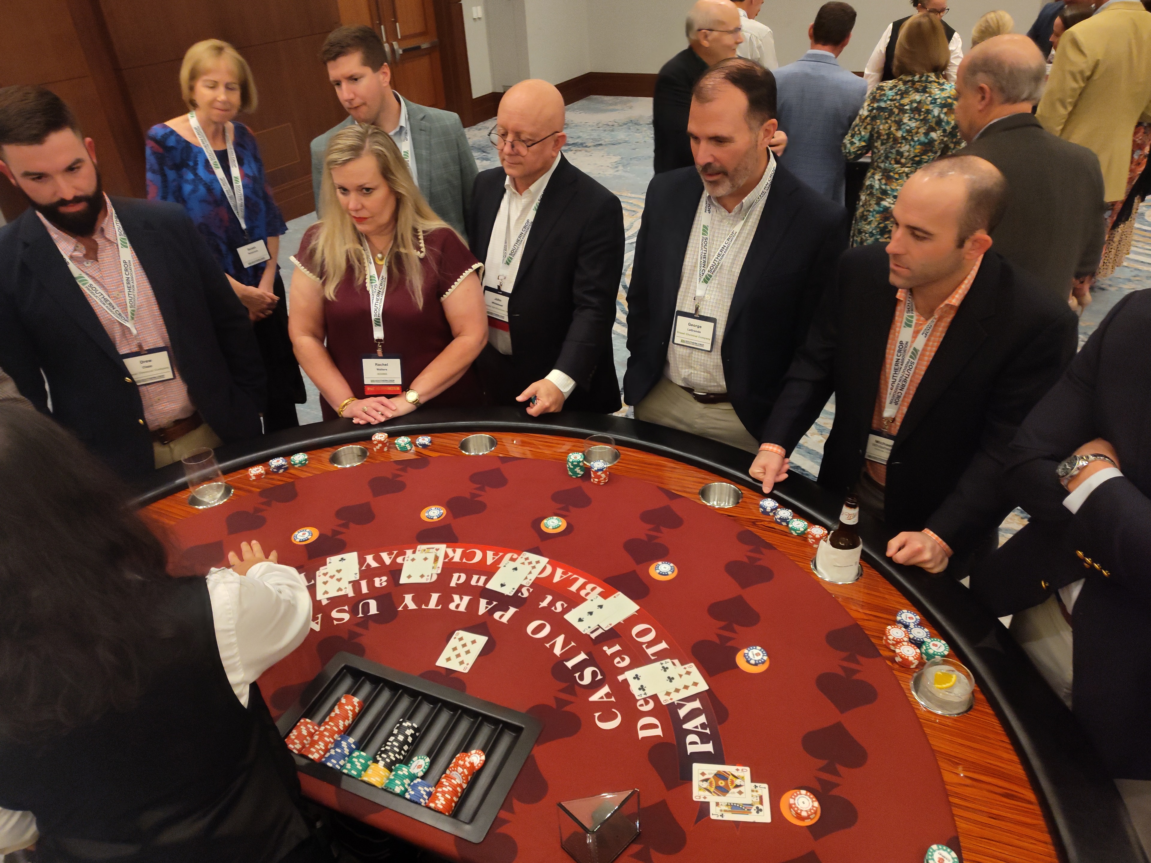 Overhead view of guests around a Casino Party USA red blackjack table at a Jacksonville event