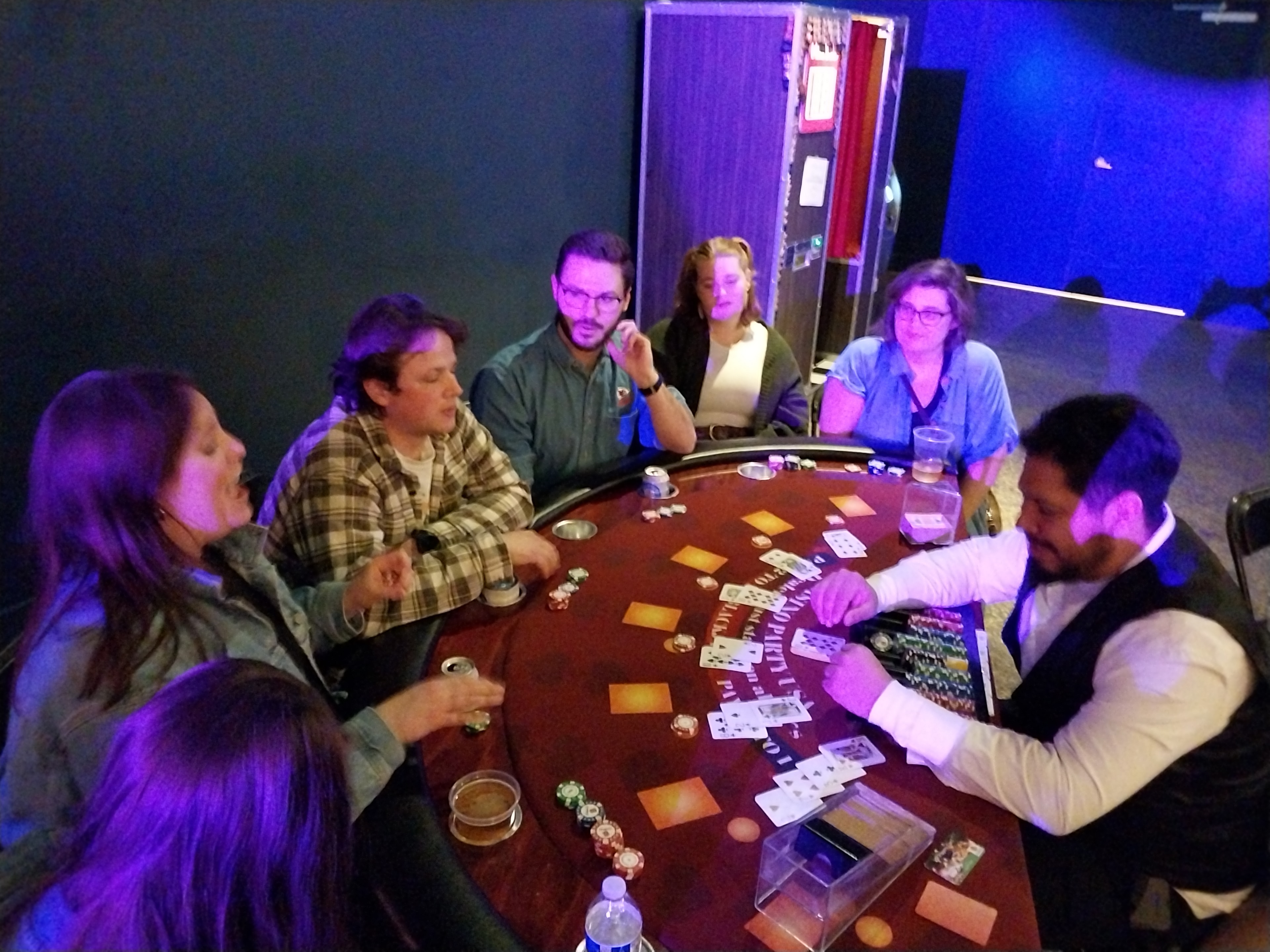 Guests playing blackjack under purple lighting at a Casino Party USA event in Kansas City