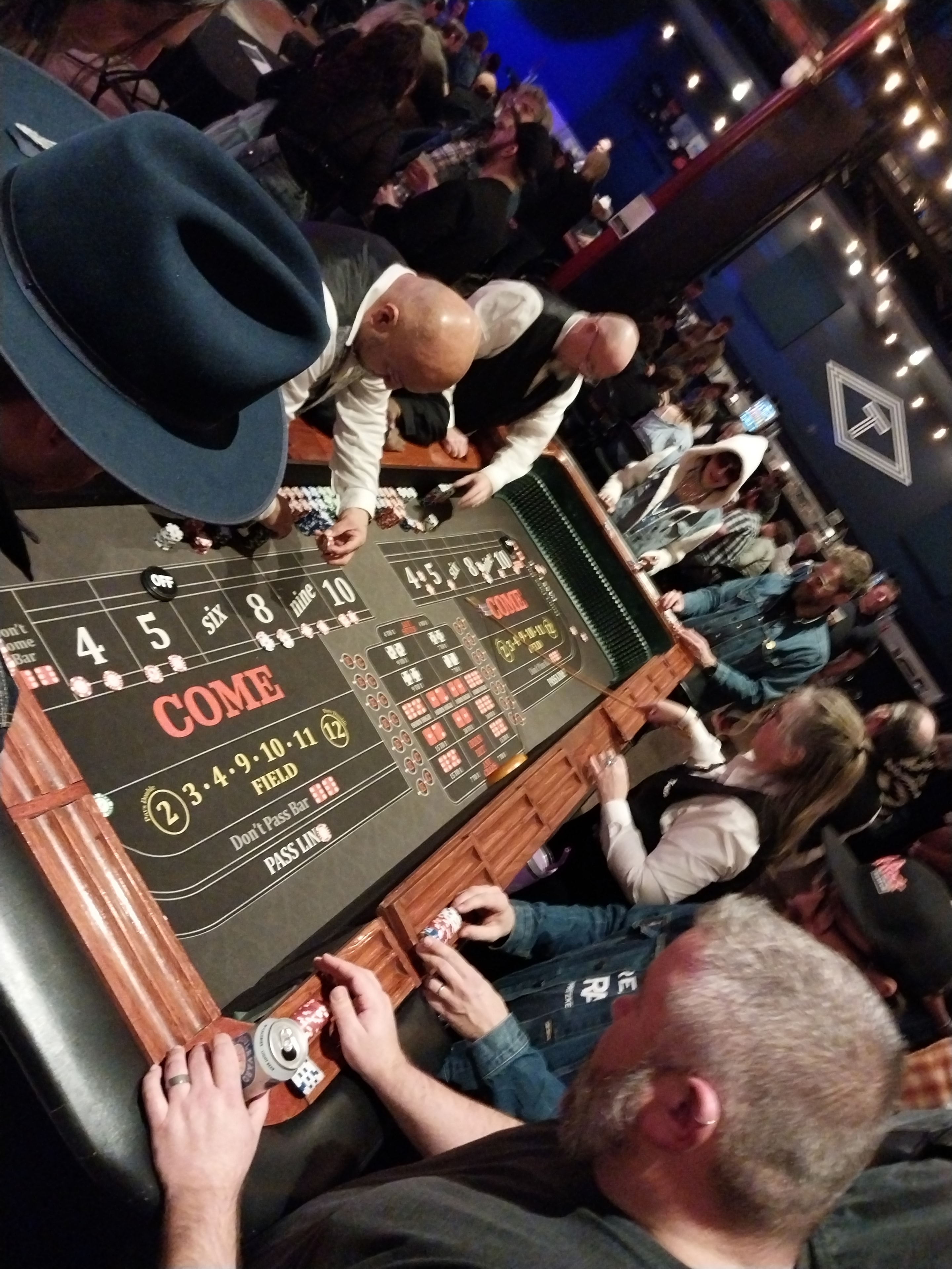 Packed craps table with large crowd at a Casino Party USA event in Kansas City