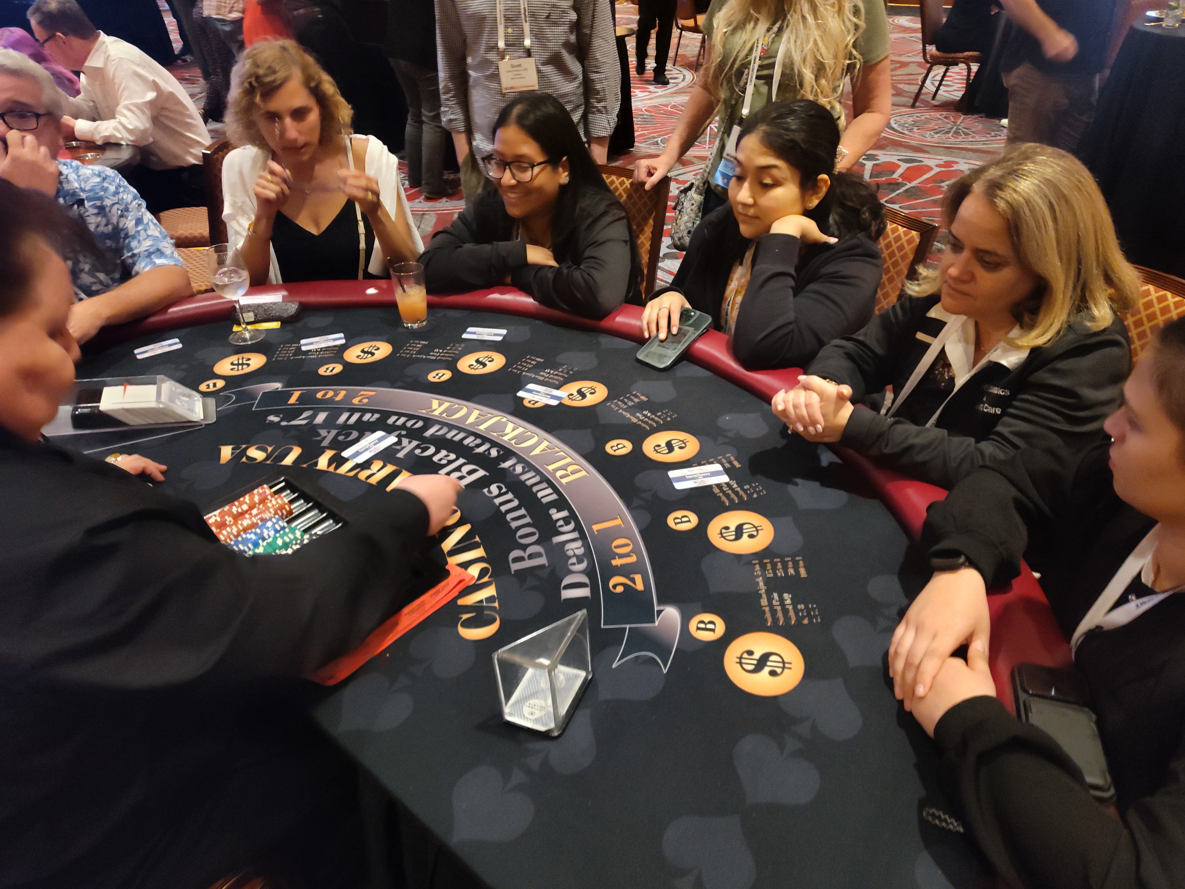 Guests and Casino Party USA dealers at a black branded blackjack table at a Las Vegas event