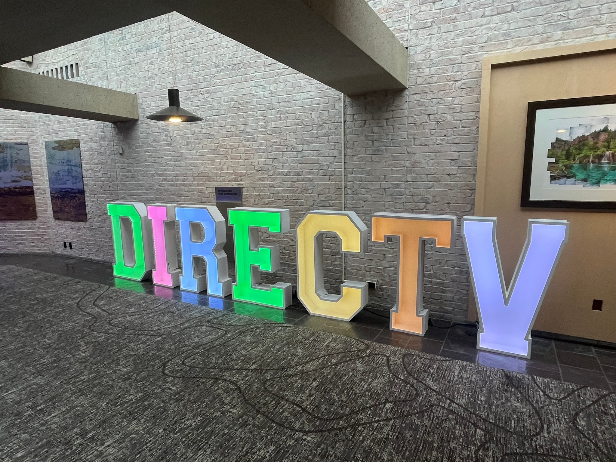Giant LED marquee letters spelling DIRECTV at corporate casino event