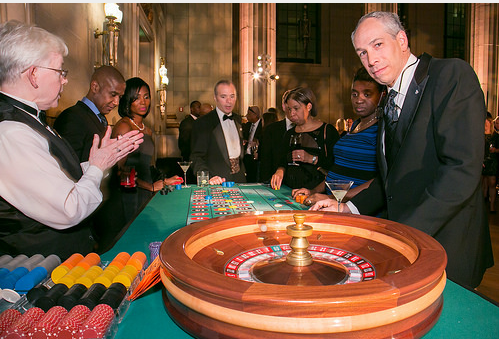 Guests gathered around a roulette table with dealer at a Northern Virginia Casino Party USA event