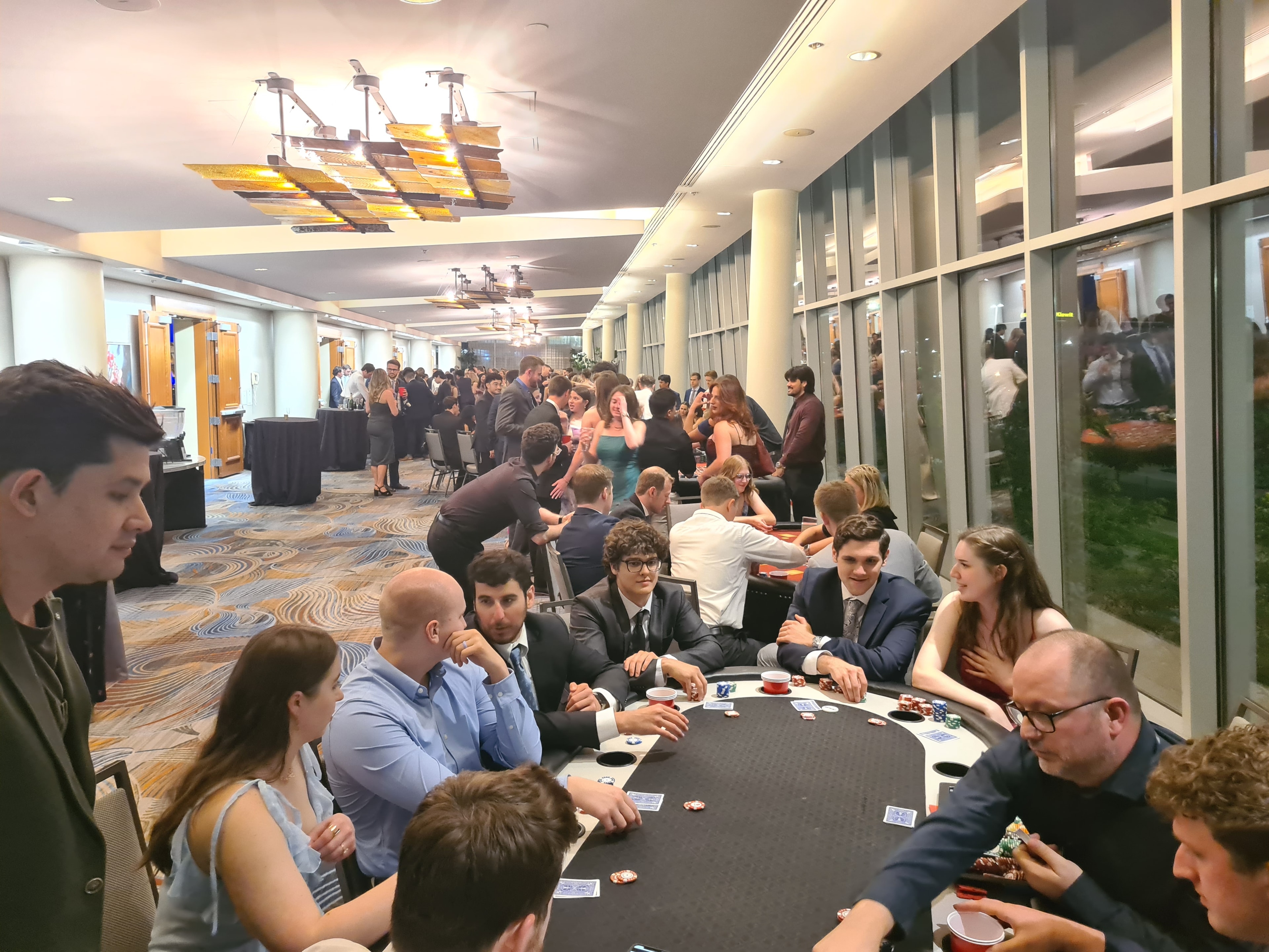 Full ballroom of guests at poker tables at an Omaha Casino Party USA event