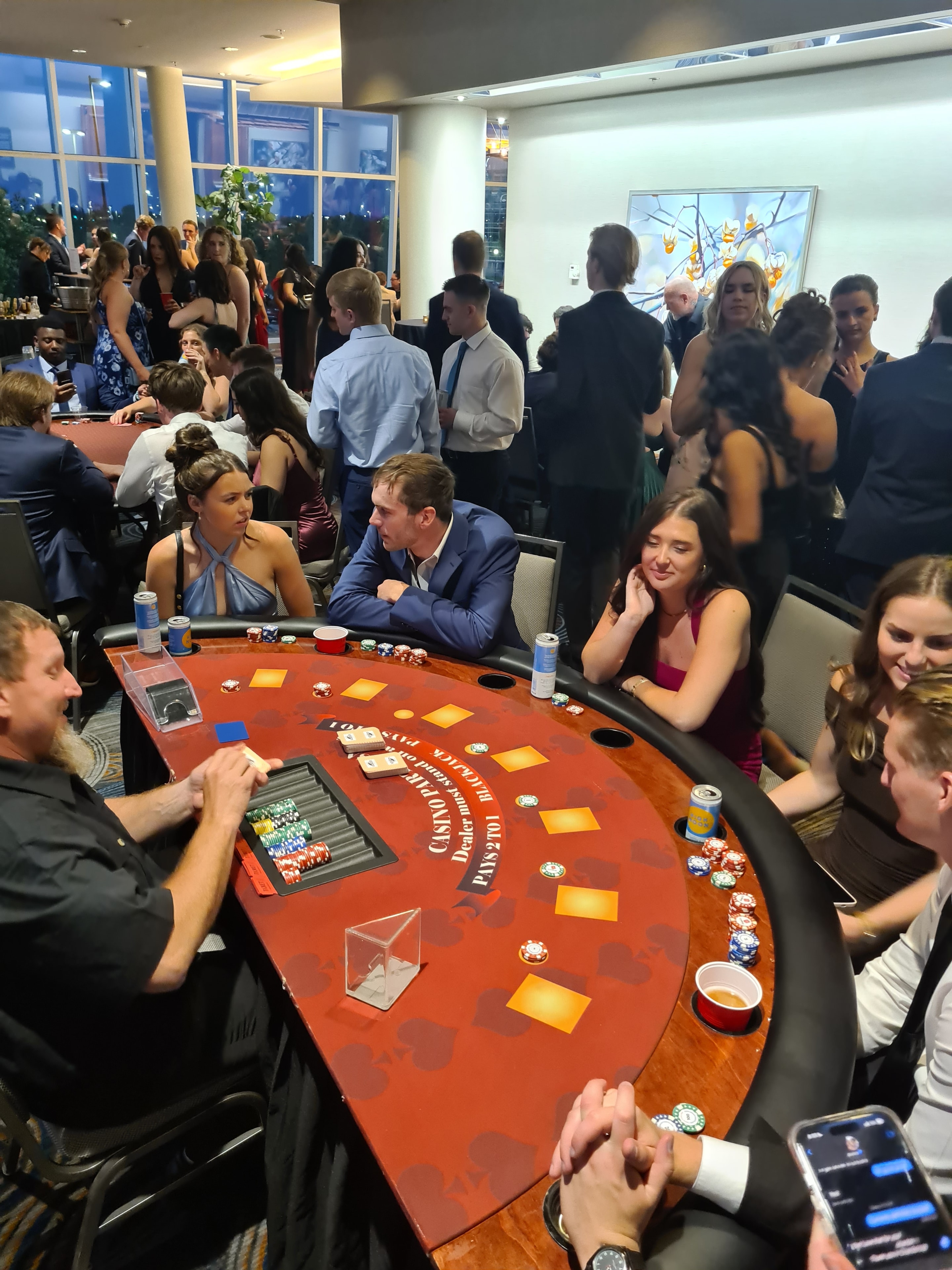 Guests crowded around a Casino Party USA blackjack table at an Omaha event