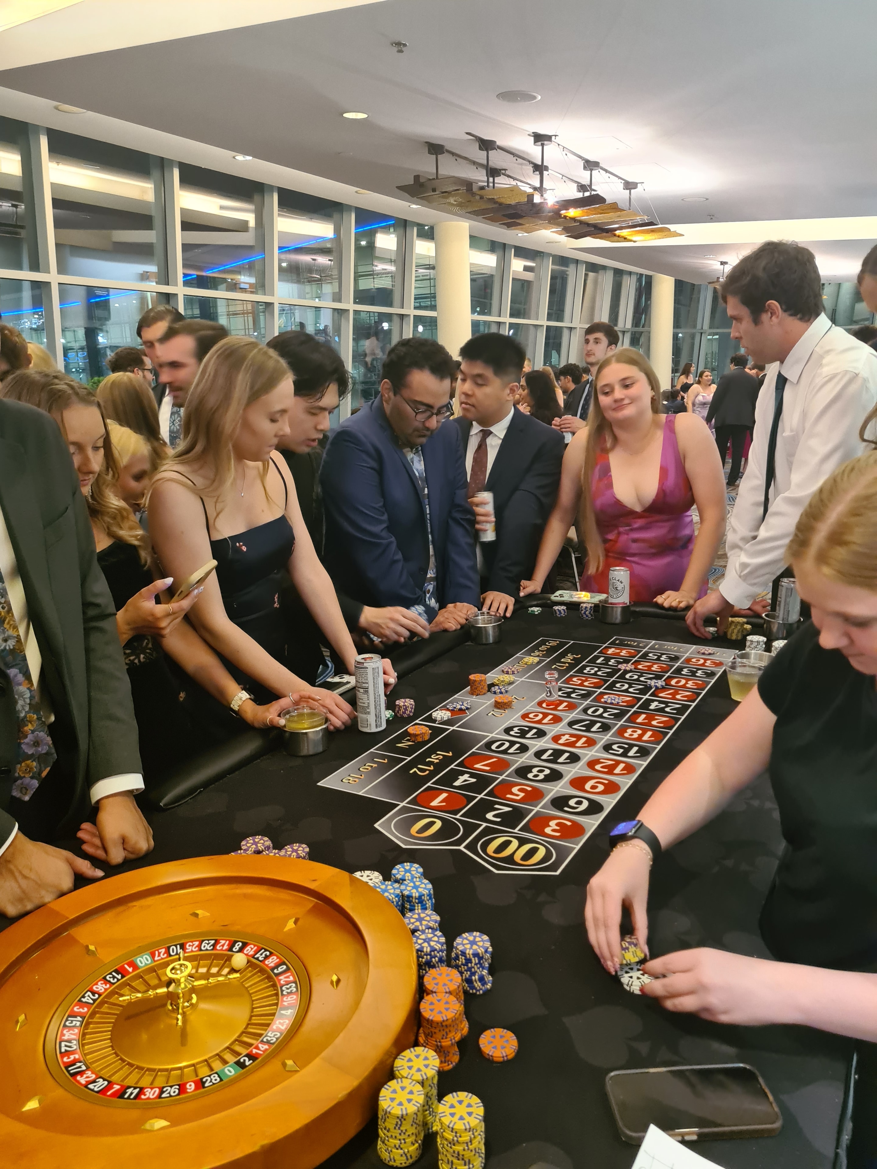 Guests crowded around a roulette table at an Omaha Casino Party USA event