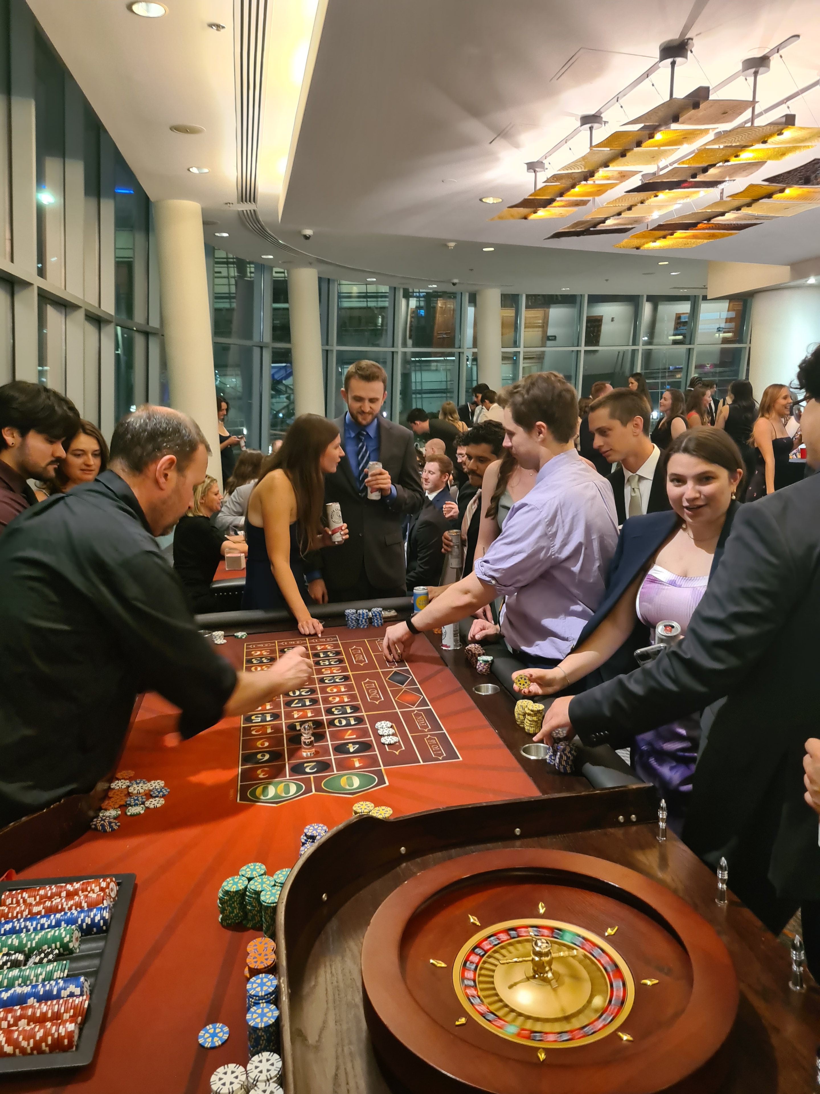 Guests at a roulette table with city views at an Omaha Casino Party USA event