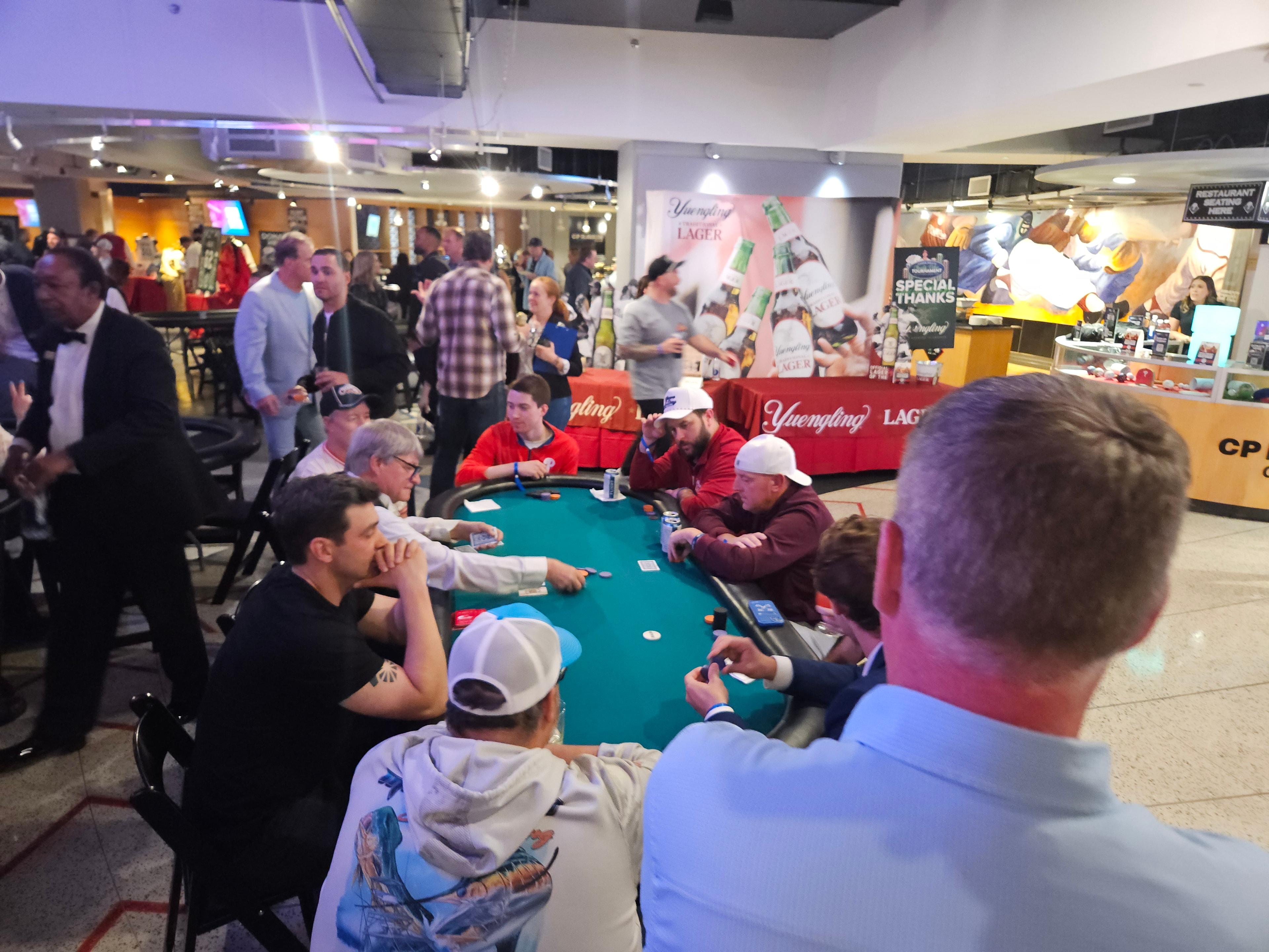 Guests at poker tables with Yuengling sponsorship at a Casino Party USA Philadelphia event