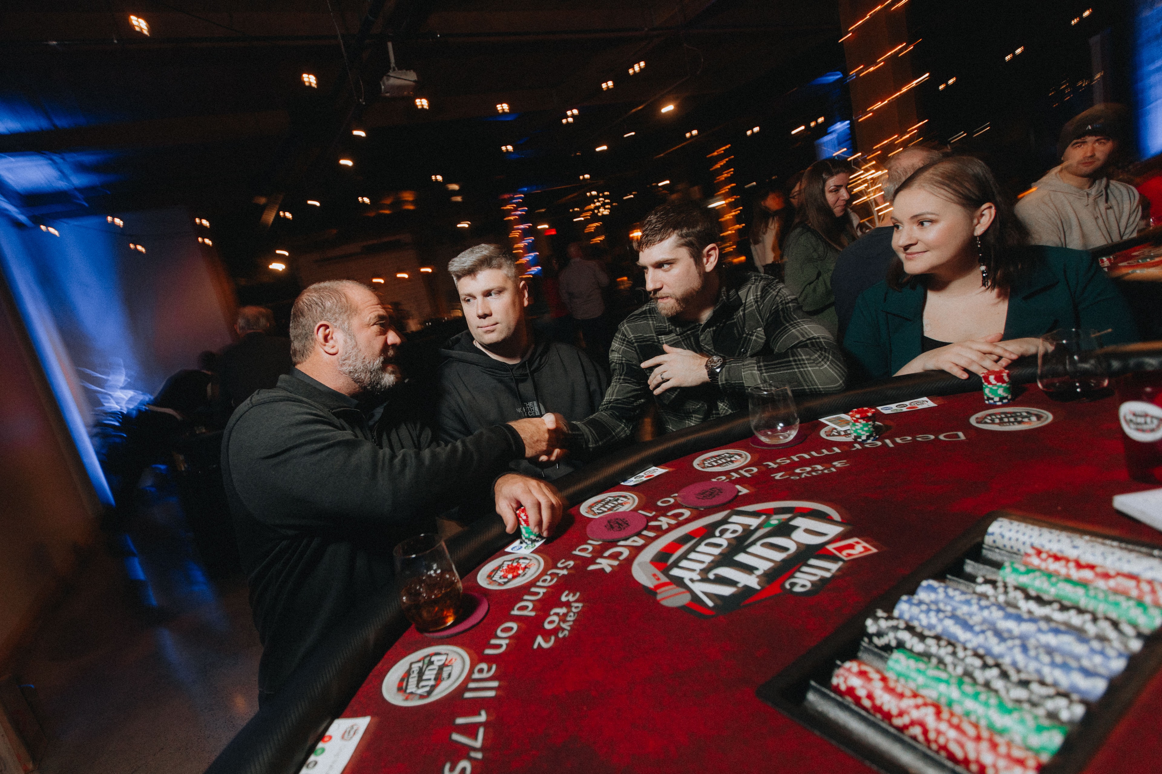 Guests enjoying blackjack under blue ambient lighting at a Portland Oregon casino night event