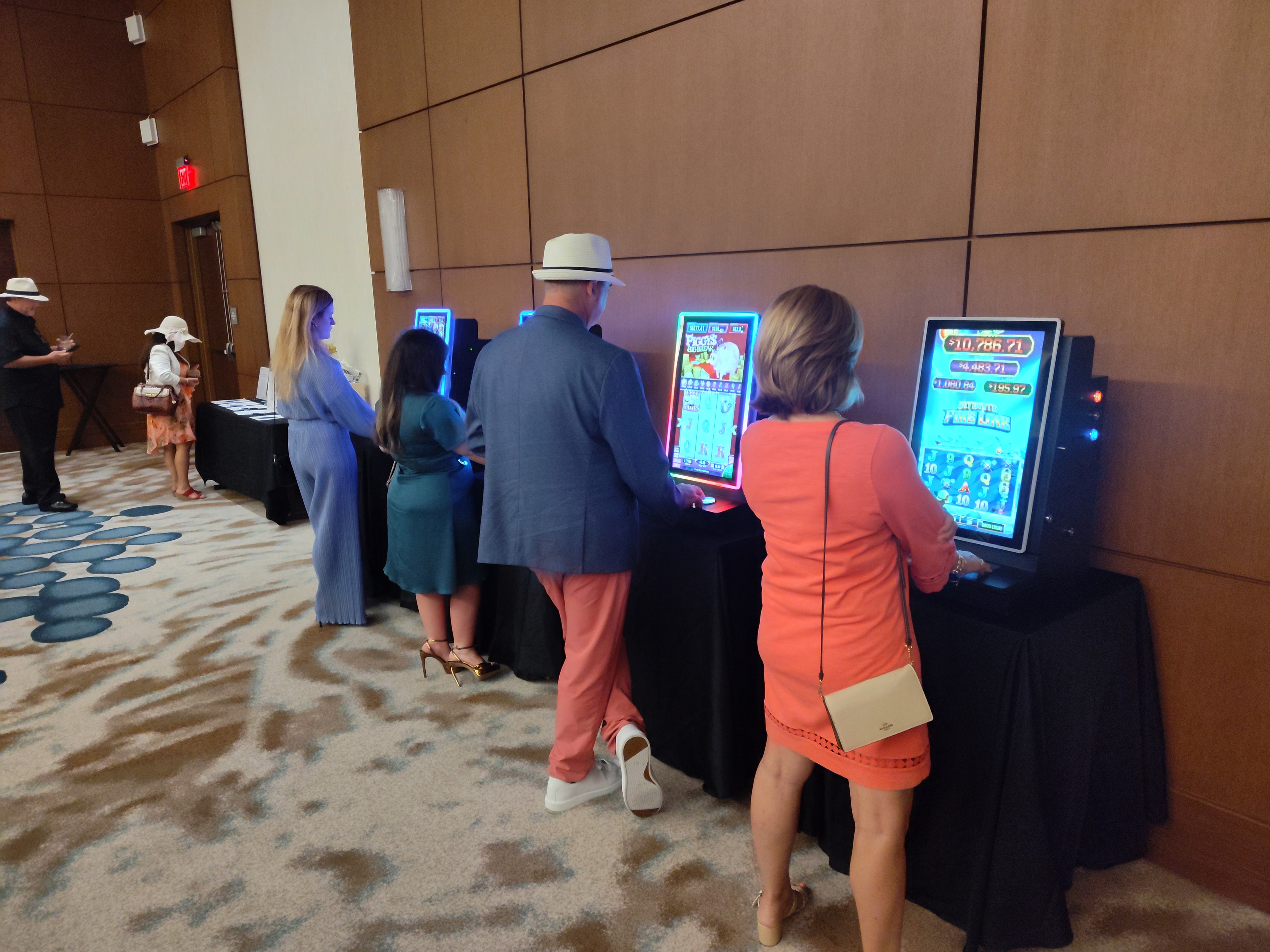 Guests playing colorful slot machines at a Casino Party USA evening event