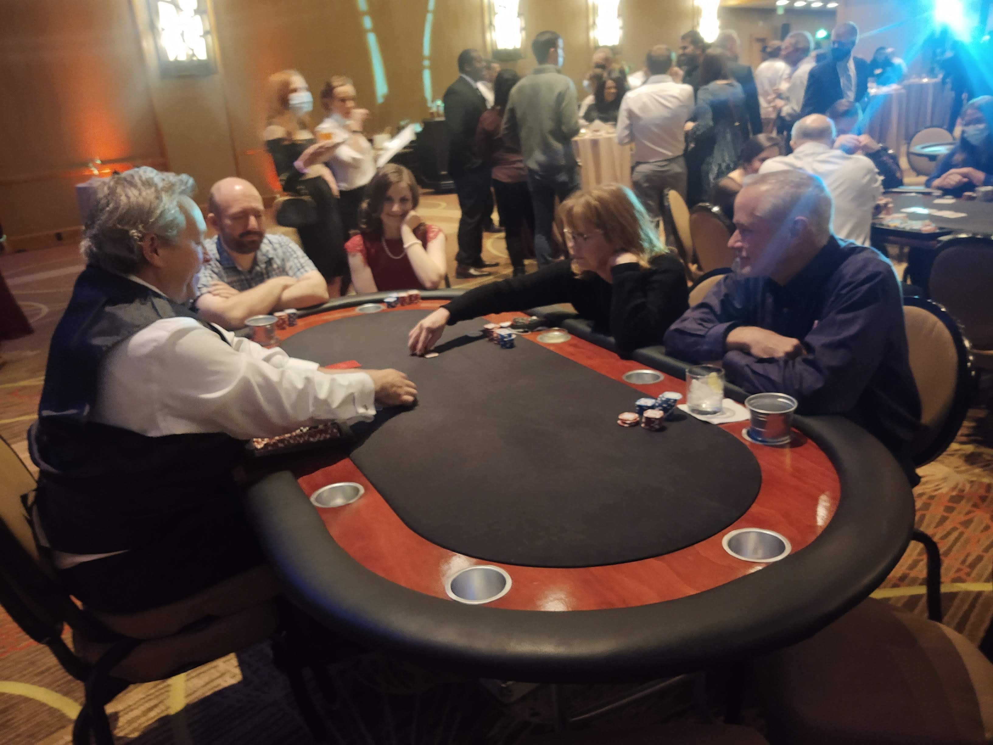 Guests playing poker at a Tampa Casino Party USA event