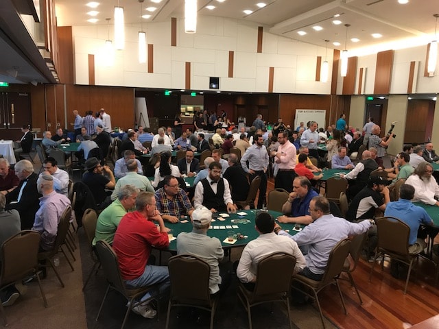 Large poker tournament with dozens of guests at tables in a Washington DC Casino Party USA event